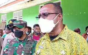 The Bupati of West Papua's Maybrat Regency, Bernard Sagrim, alongside Indonesian military discussing logistical support to displaced people in the region.