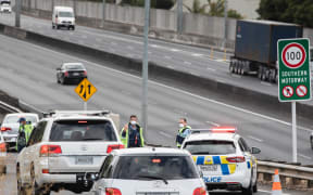 Police check motorists going on motorway in Auckland the day before the Easter long weekend begins.