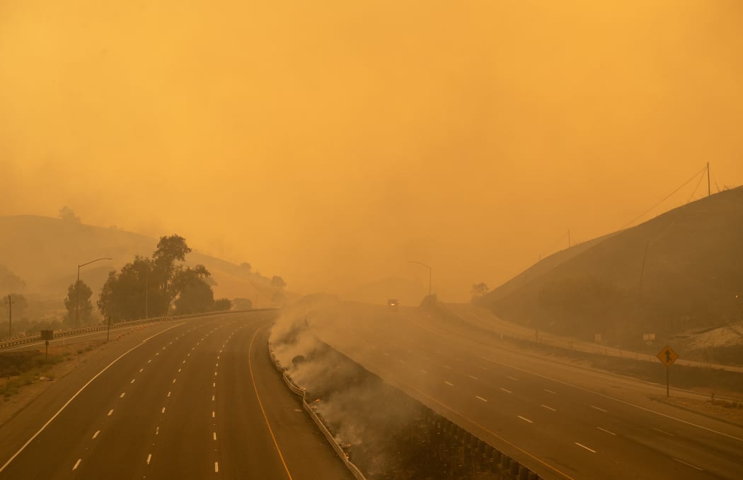 A firetruck drives along a closed Interstate 80 as flames from the LNU Lightning Complex fire continue to spread in Fairfield, California on 19 August, 2020.