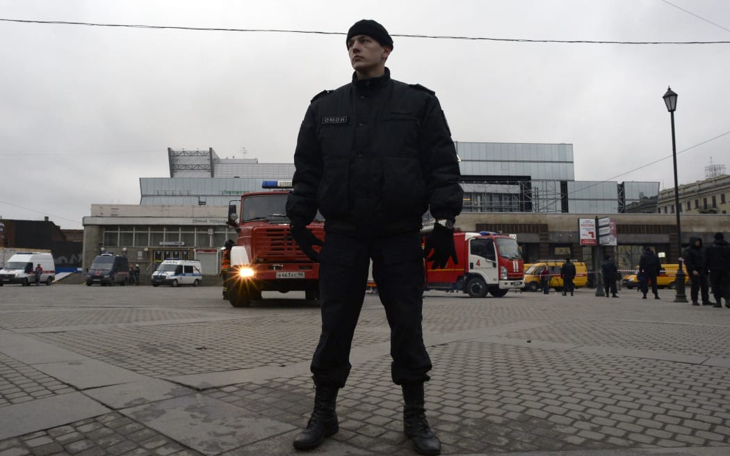 A riot police officer guards the area next to the entrance to Sennaya Square metro station in Saint Petersburg.