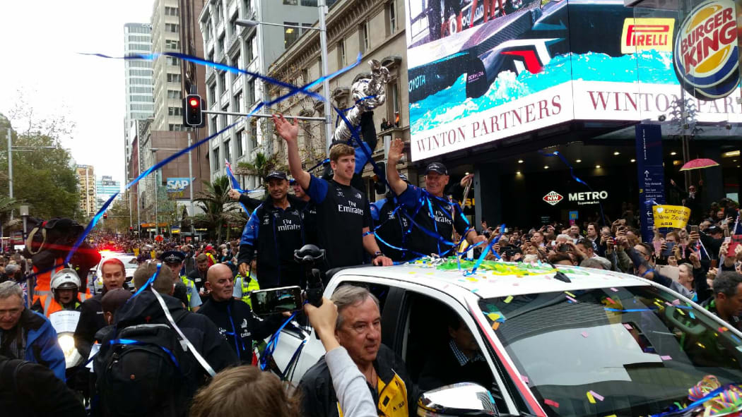 Tens of thousands of America's Cup fans are lining Auckland's central streets to catch a glimpse of the victorious team and the silverware.