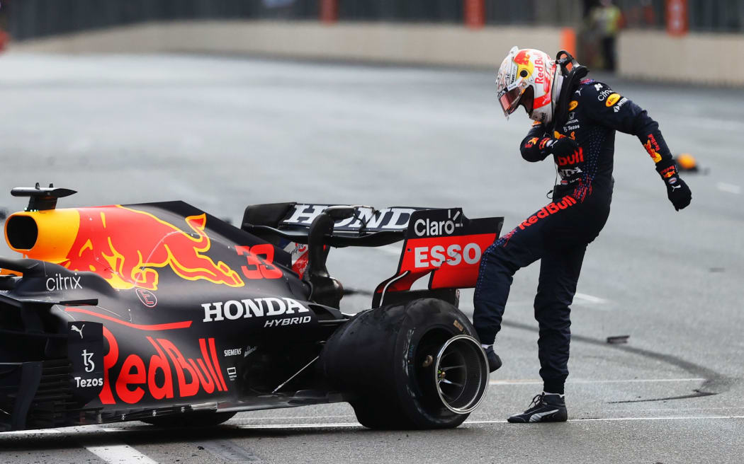 :Max Verstappen of Netherlands and Red Bull Racing kicks his tyre as he reacts after crashing during the F1 Grand Prix of Azerbaijan at Baku City Circuit on June 06, 2021 in Baku, Azerbaijan.