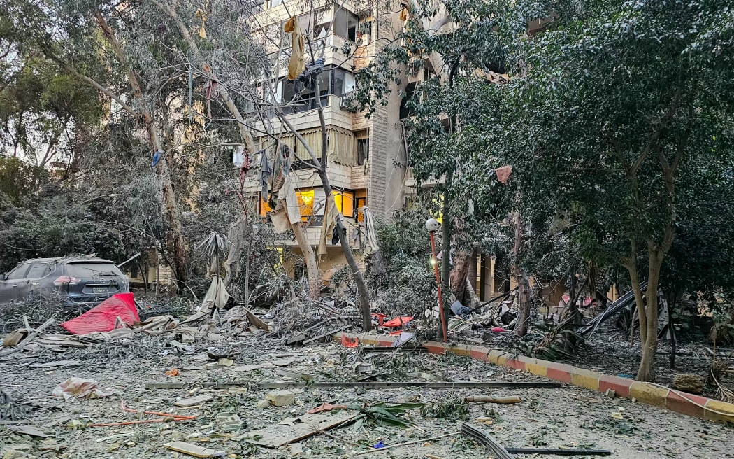 Debris is seen around a building damaged after an Israeli airstrike in Beirut's southern suburb neighborhood of Haret Hreik on March 2, 2026. Israel bombarded Lebanon on March 2, expanding conflict across the region after the massive Israel-US attack on Iran that President Donald Trump launched to topple Tehran's ruling clerics. (Photo by AFP)