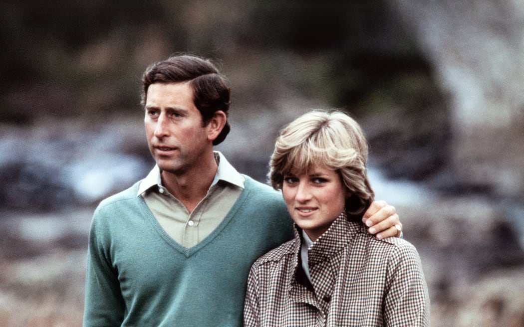 Prince Charles, Prince of Wales, wearing a kilt, and Diana, Princess of Wales, pose for photographers beside the River Dee in Scotland during their post-honeymoon visit to the Royal Residence at Balmoral Castle, on August 19, 1981. (Photo by POOL / AFP)