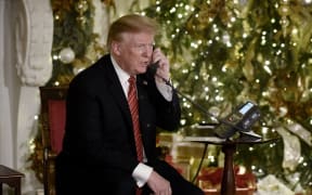 US President Donald Trump participates in NORAD Santa Tracker phone calls in the White House .