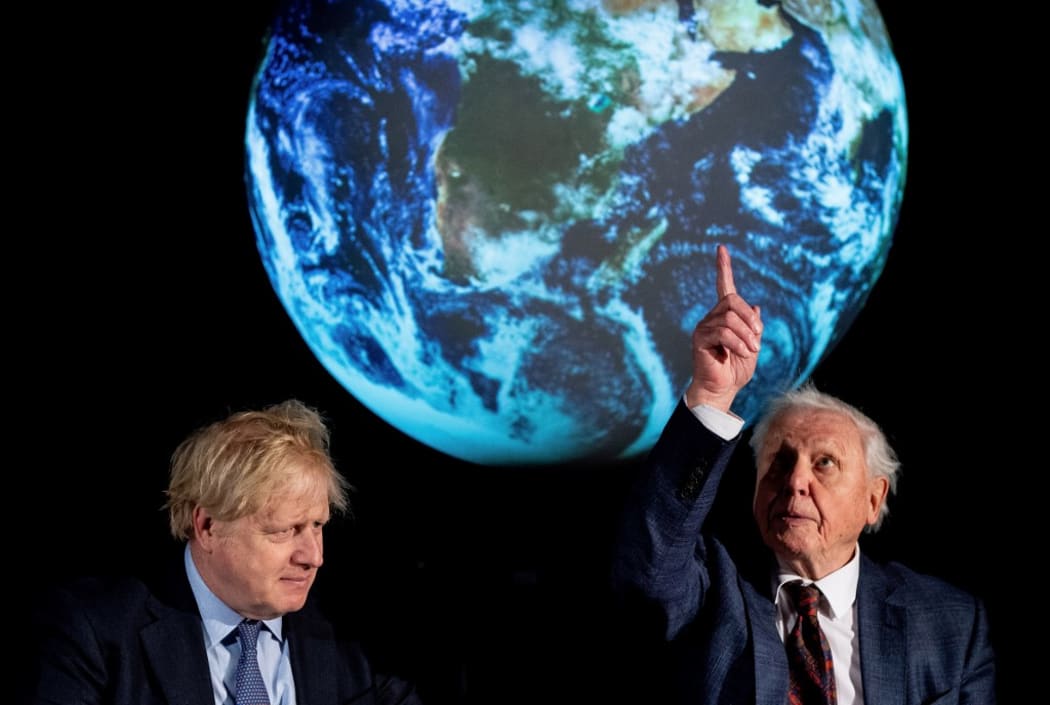Britain's Prime Minister Boris Johnson (L) sits with British broadcaster and conservationist David Attenborough, during an event to launch the United Nations' Climate Change conference, COP26, in central London on February 4, 2020