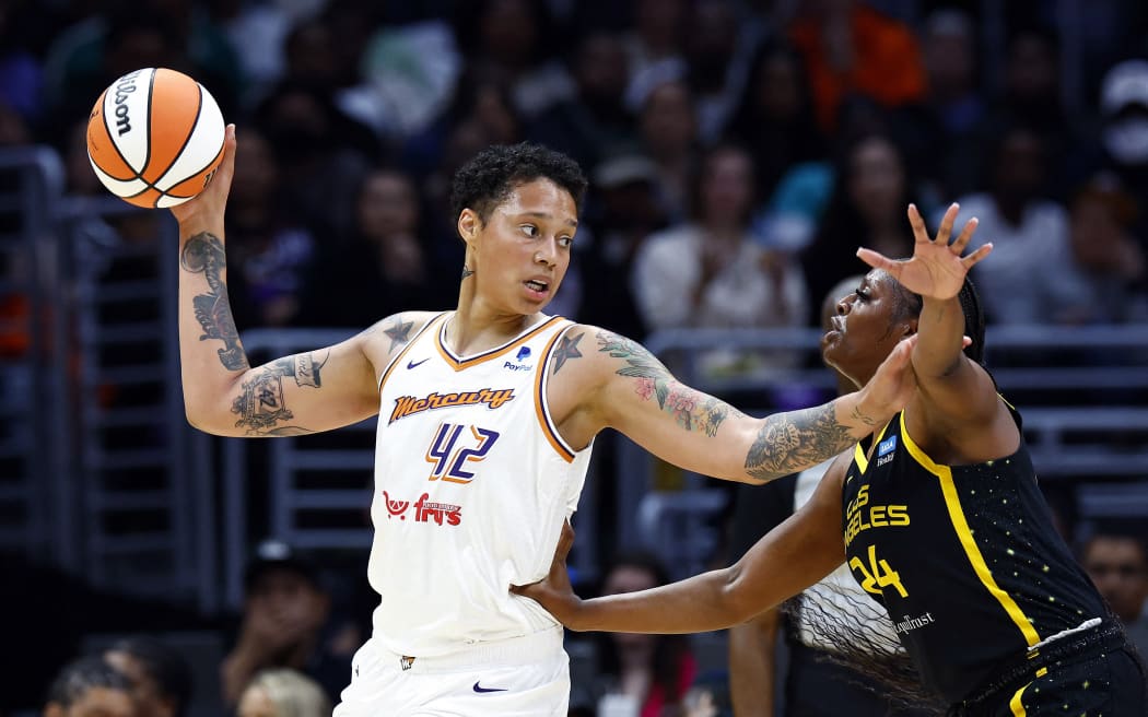 Brittney Griner of the Phoenix Mercury controls the ball against Joyner Holmes of the Los Angeles Sparks in their WNBA game in Los Angeles.