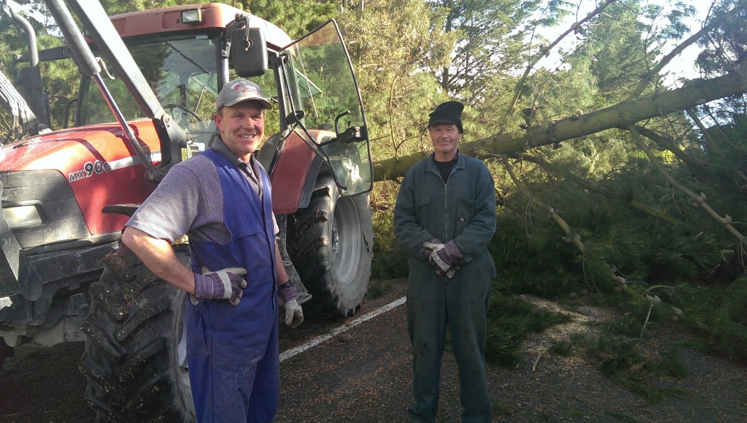 Cran Dalgetty and Murray Howard clear fallen trees in West Melton.