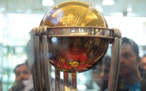 Indian fans look at the 2015 ICC Cricket World Cup trophy on display in Kolkata.