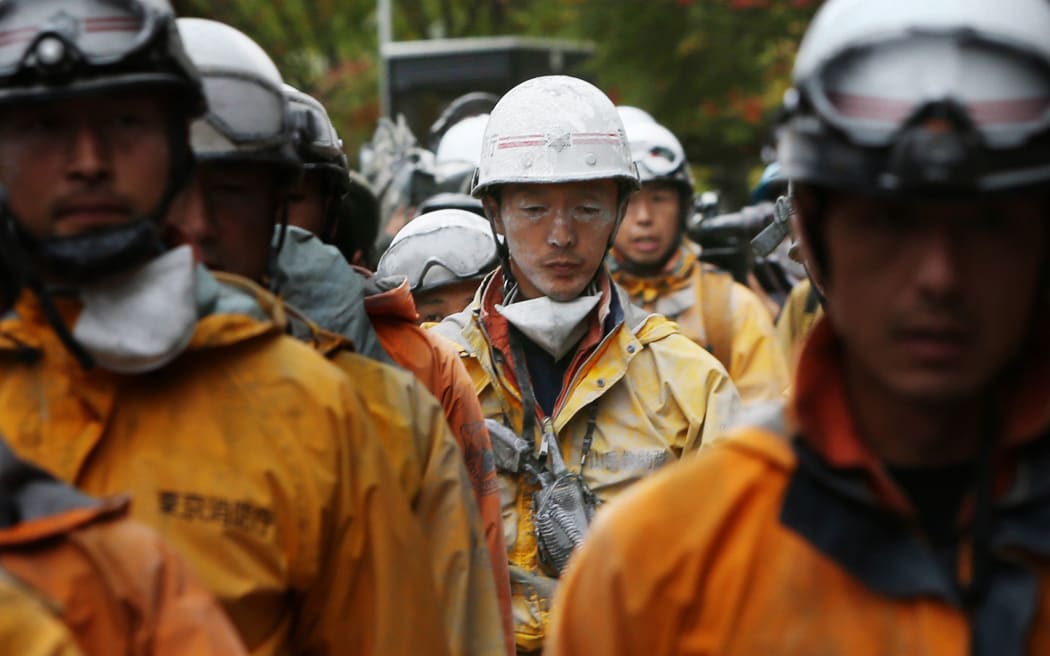 Firefighters come down from Mount Ontake on 2 October, five days after the volcano erupted at the weekend.