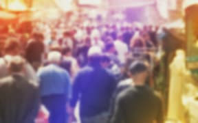 Blurred Crowd of People On Street, unrecognizable crowded population as blur urban background, Vintage Toned Image.
