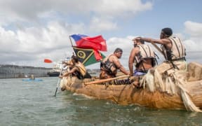A Pacific Island canoe and a ship - Climate change demonstration