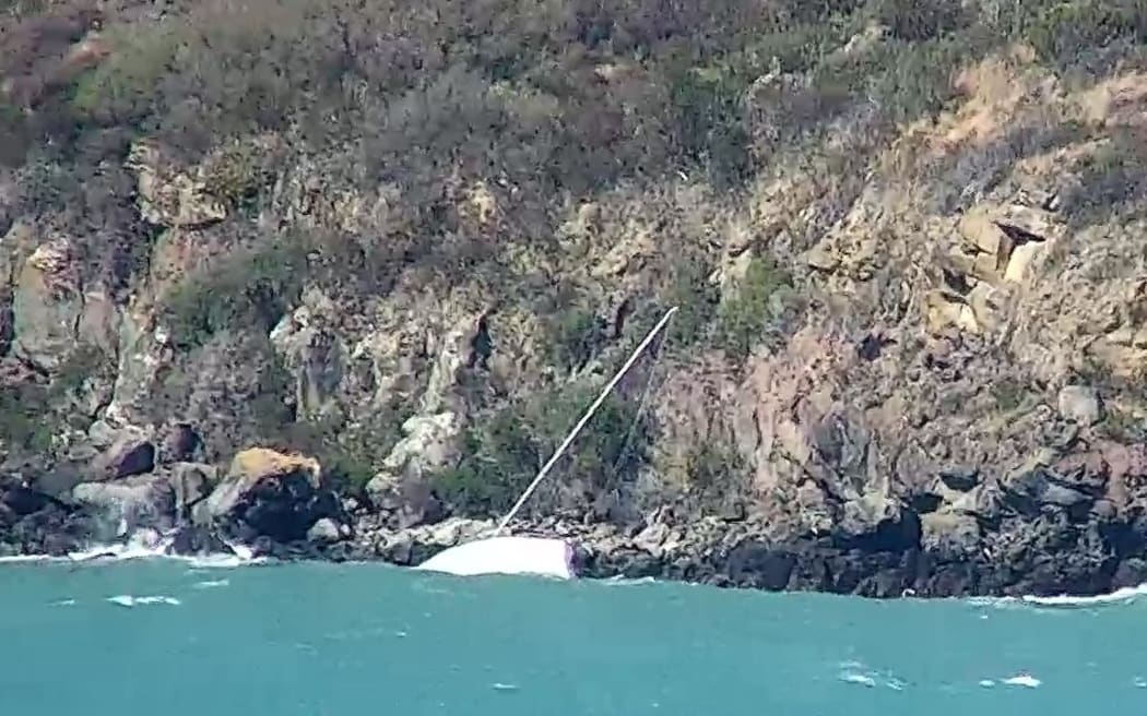 An Environment Canterbury photo of a yacht that ran aground at the bottom of a cliff on Banks Peninsula.