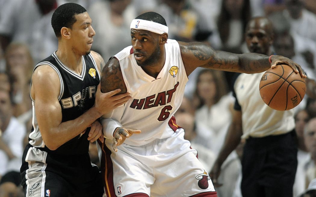 The Miami Heat's LeBron James works off the dribble against the San Antonio Spurs' Danny Green in Miami in June.