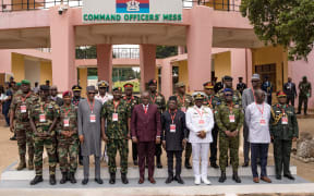 Ghana's Chief of Defence Staff, Vice Admiral Seth Amoama (1st row 4th R) and Ghana's Defence Minister, Dominic Nitiwul (1st row C) poses for a group photo with Economic Community of West African State (ECOWAS) delegates during the Extraordinary meeting of ECOWAS in Accra, Ghana, on August 17, 2023. West African military chiefs met in Ghana on August 17, 2023 to coordinate a possible armed intervention to reverse a coup in Niger, as Germany called for EU sanctions against the rebel leaders. Alarmed by a series of military takeovers in the region, the Economic Community of West African States (ECOWAS) has agreed to activate a "standby force to restore constitutional order" in Niger. ECOWAS is demanding Niger's coup leaders release President Mohamed Bazoum after his July 26 ouster, warning that the bloc could send in troops as a last resort if negotiations fail. (Photo by GERARD NARTEY /...