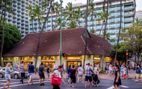 Busy intersection on Kalakaua Avenue on April 27, 2014 in Waikiki, Hawaii Kalakaua Avenue is the favorite luxury shopping strip for tourists visiting Hawaii