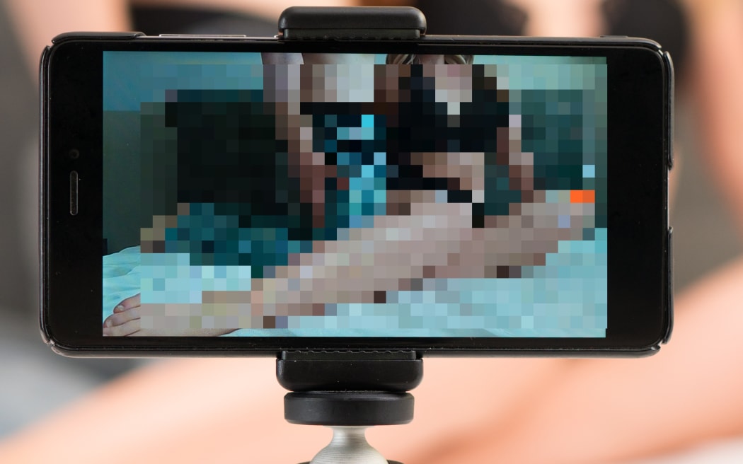 Couple recording their adult video on mobile phone.