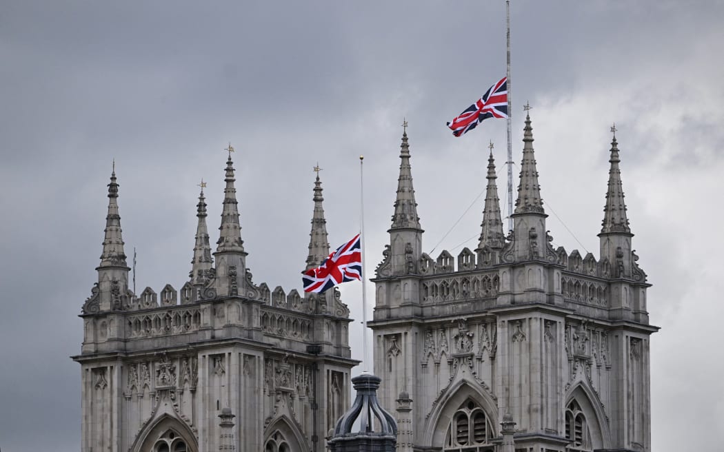 The Union Jack flag flies half mast at Westminster Abbey in London on 15 September, 2022, following the death of Britain's Queen Elizabeth II on 8 September. Queen Elizabeth II will lie in state until 0530 GMT on 19 September 19, a few hours before her funeral, with huge queues expected to file past her coffin to pay their respects.