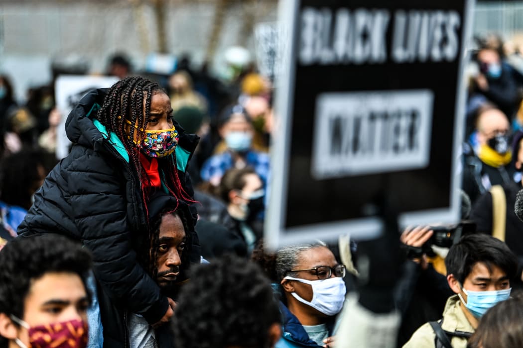 People react as the verdict is announced in the trial of former police officer Derek Chauvin outside the Hennepin County Government Center in Minneapolis, Minnesota on April 20, 2021.