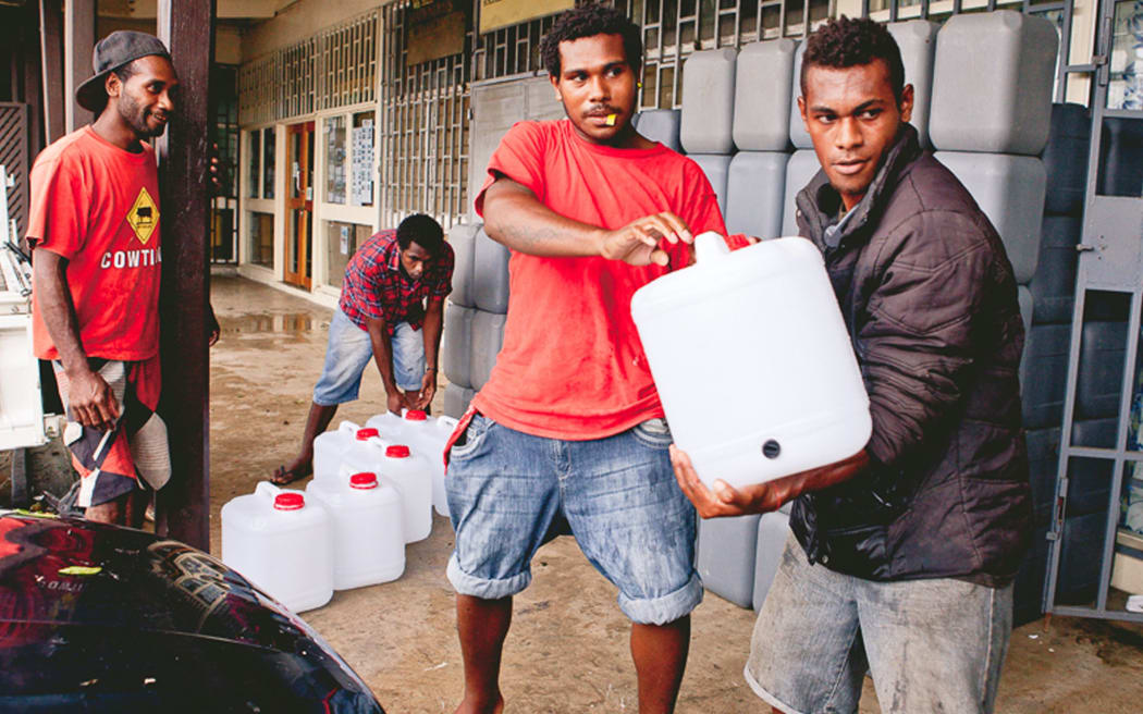 World Vision staff distributing clean water.