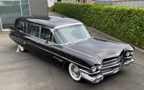 Harbour City Funeral Home's 1959 Cadillac hearse has been named 'Colin' in honour of Wellington designer and graphic artist Colin Simon.