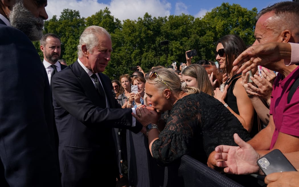 King Charles III greets members of the public waiting in the crowd upon arrival Buckingham Palace in London, a day after Queen Elizabeth II died.