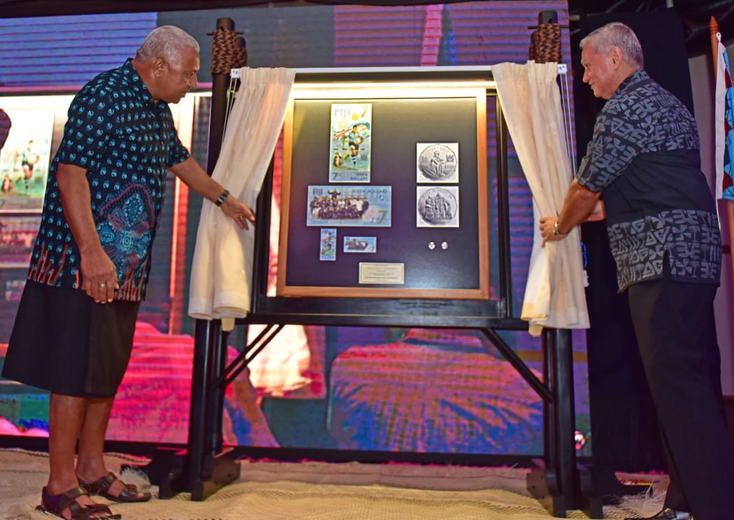 Fiji's Prime Minister Frank Bainimarama unveils the new Commemorative rugby 7s Banknote and Coins with RBF Governor Barry Whiteside.