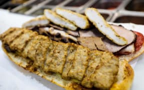 Collins' sandwich creation includes 'all the meats', except for meatballs.