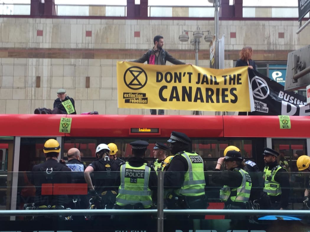 Extinction Rebellion protesters on the roof of a train at Canary Wharf, London, 25 April, 2019.
