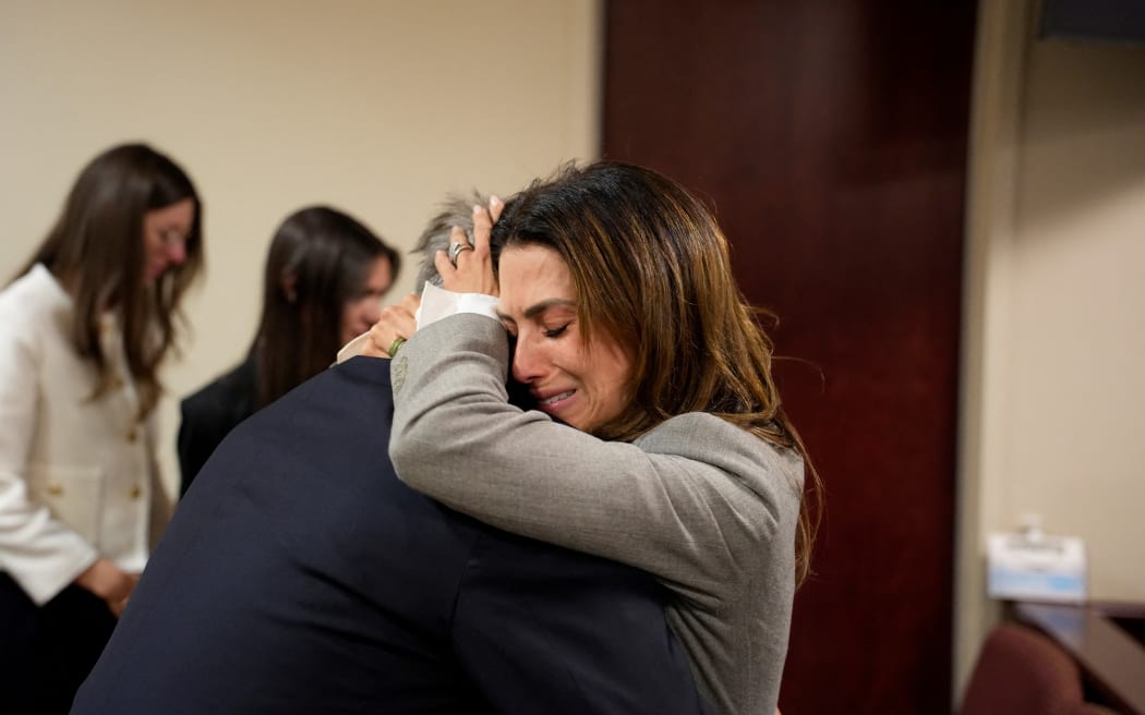 SANTA FE, NEW MEXICO - JULY 12: Alec Baldwin and his wife Hilaria Baldwin embrace during his trial for involuntary manslaughter in First Judicial District Court on July 12, 2024 in Santa Fe, New Mexico. The trial for involuntary manslaughter was dismissed by a judge Friday after she ruled that key evidence over a fatal shooting on the set of "Rust" had been withheld from the defense.   Ramsay de Give-Pool/Getty Images/AFP (Photo by POOL / GETTY IMAGES NORTH AMERICA / Getty Images via AFP)