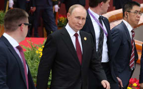 In this pool photograph distributed by the Russian state agency Sputnik, Russia's President Vladimir Putin (C) walks after taking a group photograph during a military parade marking the 80th anniversary of victory over Japan and the end of World War II, in Beijing’s Tiananmen Square on 3 September, 2025.