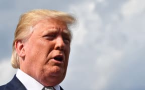 US President Donald Trump gives a statement about the recent mass shootings in El Paso and Dayton before boarding to Washington at Morristown Airport on August 04, 2019.