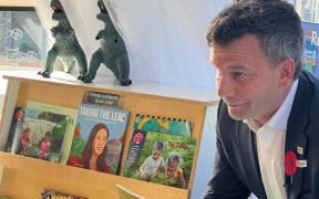 ACT leader David Seymour reads to children, next to 'Taking The Lead', a book about former prime minister Jacinda Ardern.