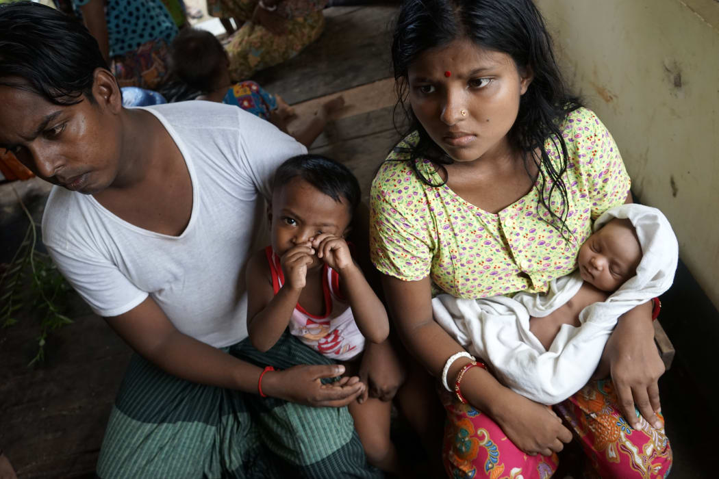 This photo taken on September 22, 2017 shows 20-year-old Hindu girl, Chaw Shaw Chaw Thee (R), who believes 23 members of her family are dead after Rohingya militants attacked their Hindu village in the Kha Maung Seik area of northern Rakhine in Myanmar.