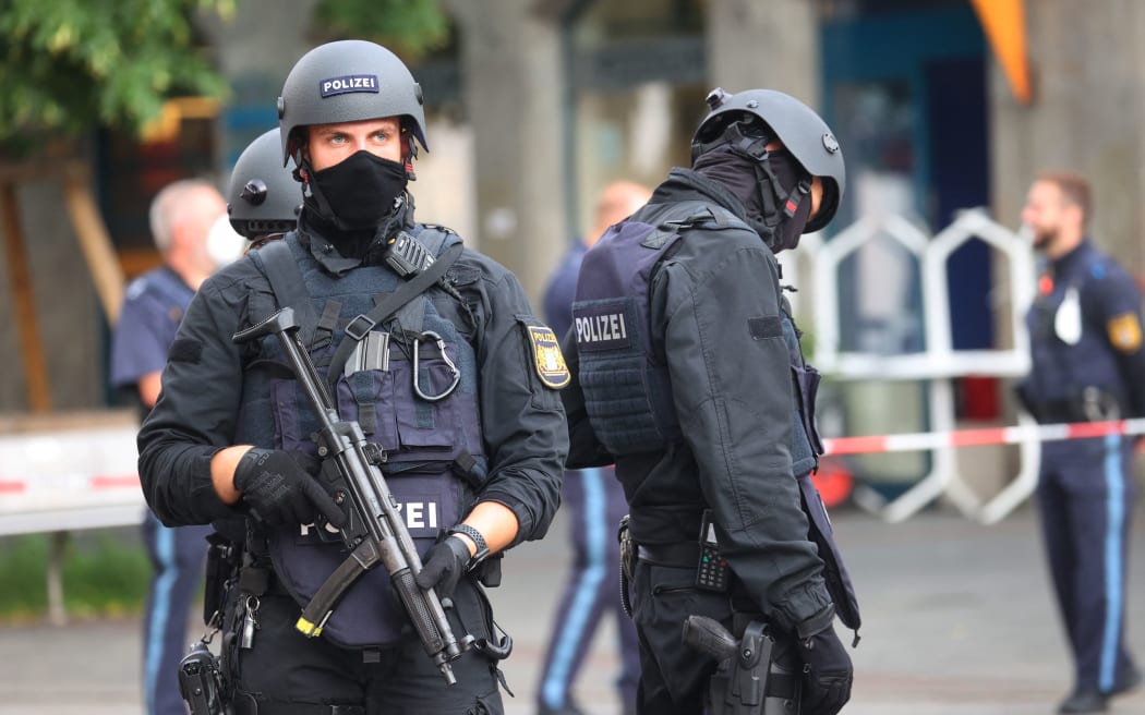 25 June 2021, Bavaria, Würzburg: Police officers stand in the city centre. According to the Deutsche Presse-Agentur, three people were killed and five injured in the knife attack in Würzburg.