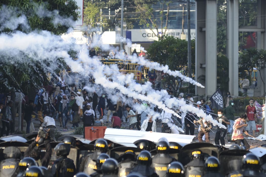 Police fired tear gas during a clash with mobs in the Tanah Abang Market area, Jakarta, Indonesia today.