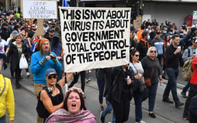 Protesters march through the streets during an anti-lockdown rally in Melbourne on September 18, 2021.