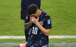 Miguel Almiron of Paraguay reacts after receiving a red card for covering his mouth while talking to another player during the FIFA World Cup.