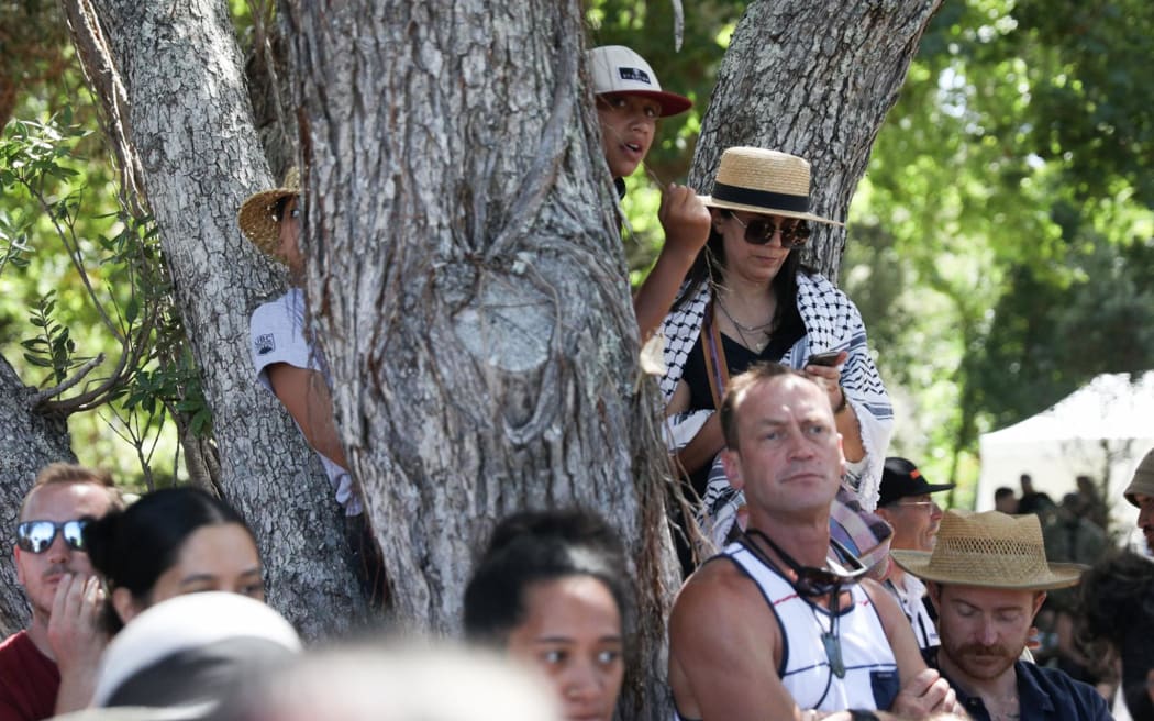 Spectators look on during the pōwhiri as a delegation including representatives from Kīngitanga, Rātana, Parihaka and Te Pāti Māori are welcomed on to Te Whare Rūnanga at the Treaty grounds, on 4 February, 2024.