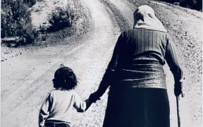 The now famous photo of Dame Whina Cooper setting off on her 1100km march to Parliament with 3-year-old granddaughter Irenee Cooper.