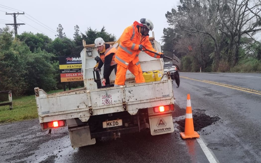 Contractors repair a large pothole at Egmont Village after extensive rain in Taranaki.