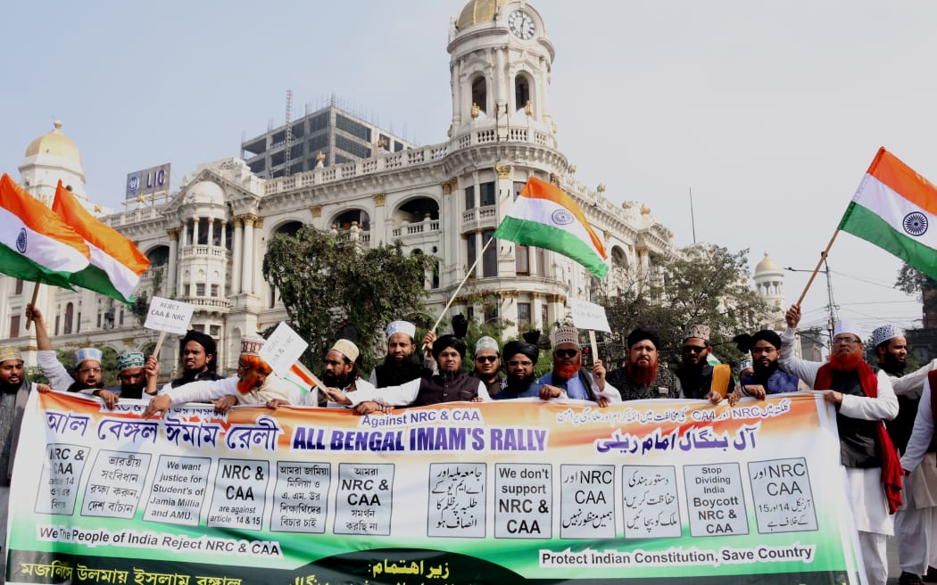 Indians shout slogans as they participate in a rally to protest against the Citizenship Amendment Act during  Kolkata Masque Imam's part in the rally