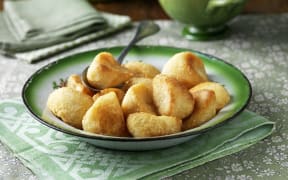 Roast potatoes in green vintage bowl (Photo by Diana Miller / Connect Images / Connect Images via AFP)