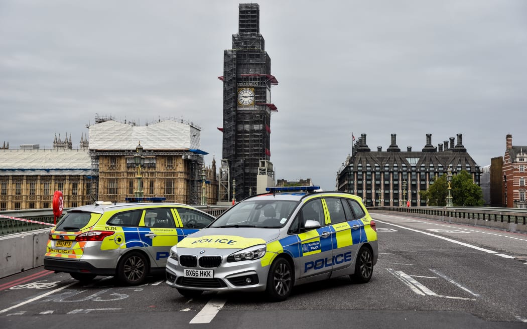Police officers secure the roads around the Houses of Parliament as forensic teams continue their work around a vehicle after it crashed into security barriers, injuring a number of pedestrians, outside the Houses of Parliament on August 14, 2018 in London, England.