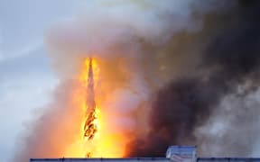 This photograph shows flames engulfing the Copenhagen's Stock Exchange building, in Copenhagen, on April 16, 2024. (Photo by Ida Marie Odgaard / Ritzau Scanpix / AFP) / Denmark OUT