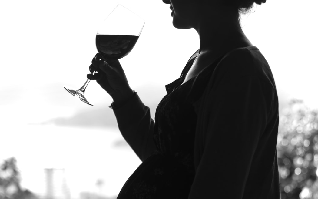 Generic pregnant woman drinking alcohol.
