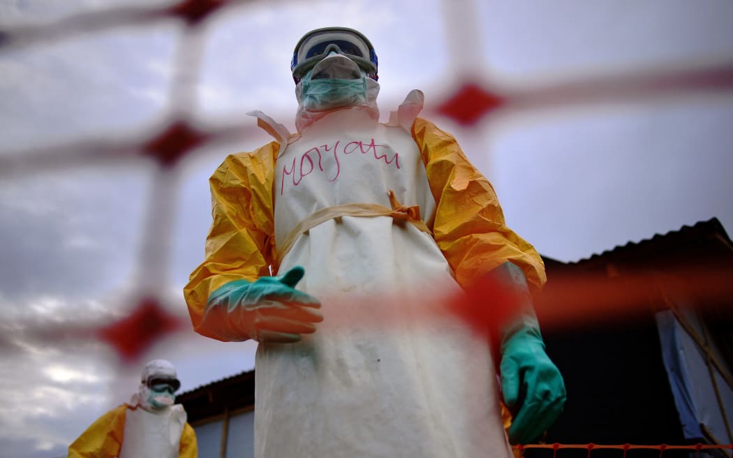 Medecins Sans Frontieres (MSF) medical staff treat the body of an Ebola victim at a facility in Kailahun, Sierra Leone.