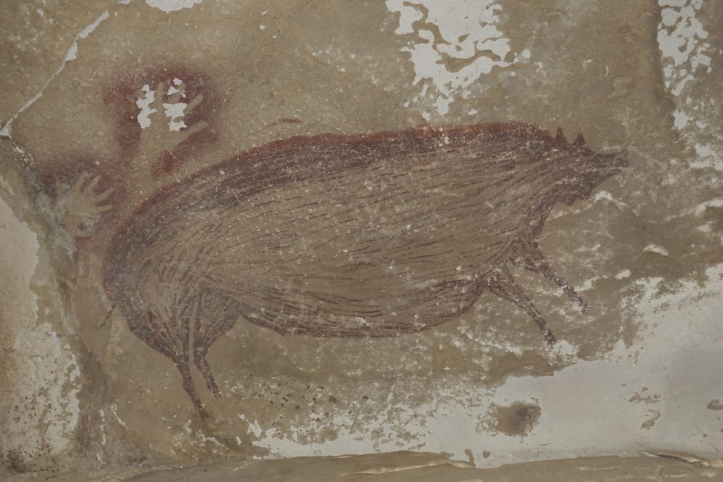 A life-sized picture of a wild pig that was made at least 45,500 years ago in Indonesia.