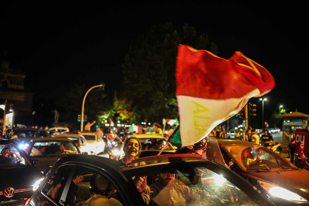 Supporters of Italy's national football team celebrate the victory of Italy at the end of UEFA EURO 2020 semi-final football match between Italy and Spain