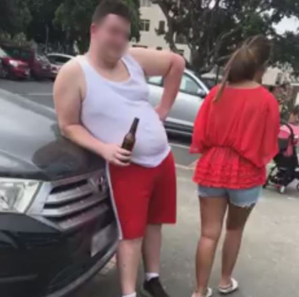 A screengrab from the video posted on social media of a woman challenging the tourists for littering at Takapuna Beach.